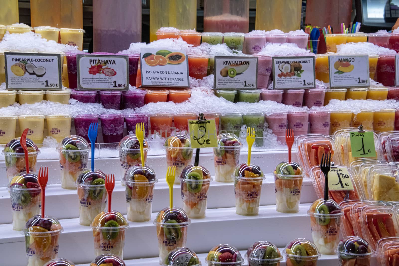 Spain, Barcelona - May 2018:  fresh fruits and smoothies on sale in La Boqueria