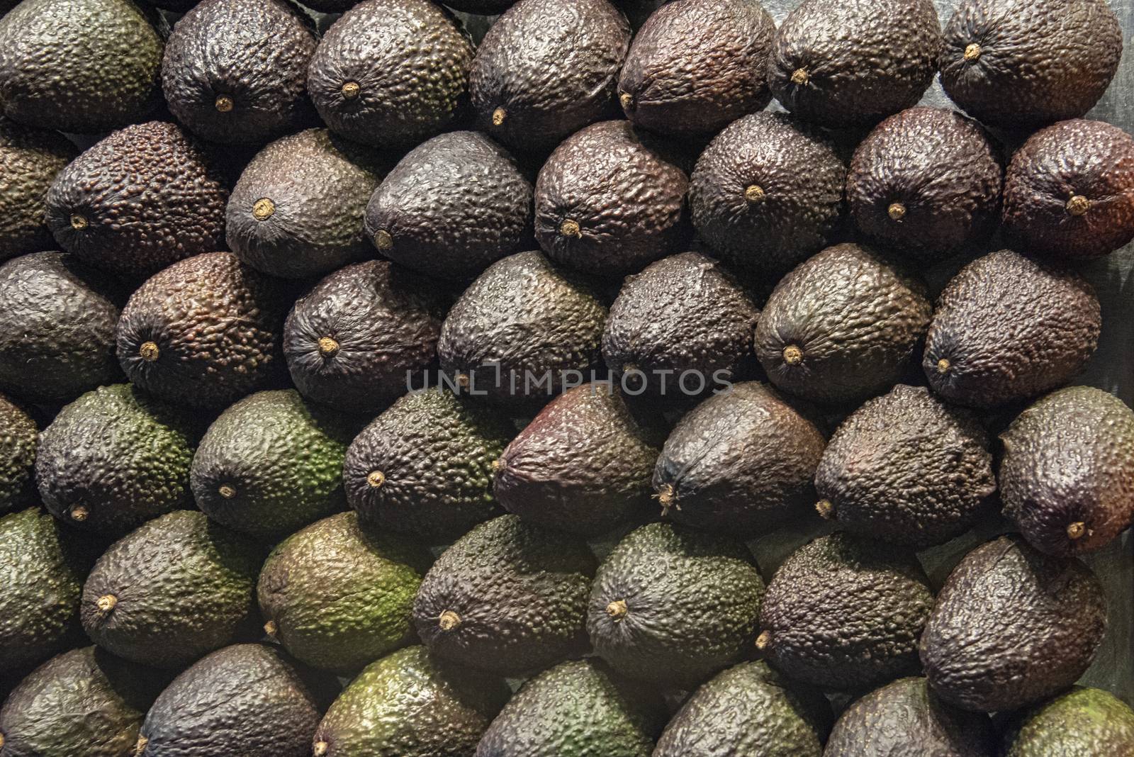 Spain, Barcelona - May 2018: Wall of stacked avocado pears