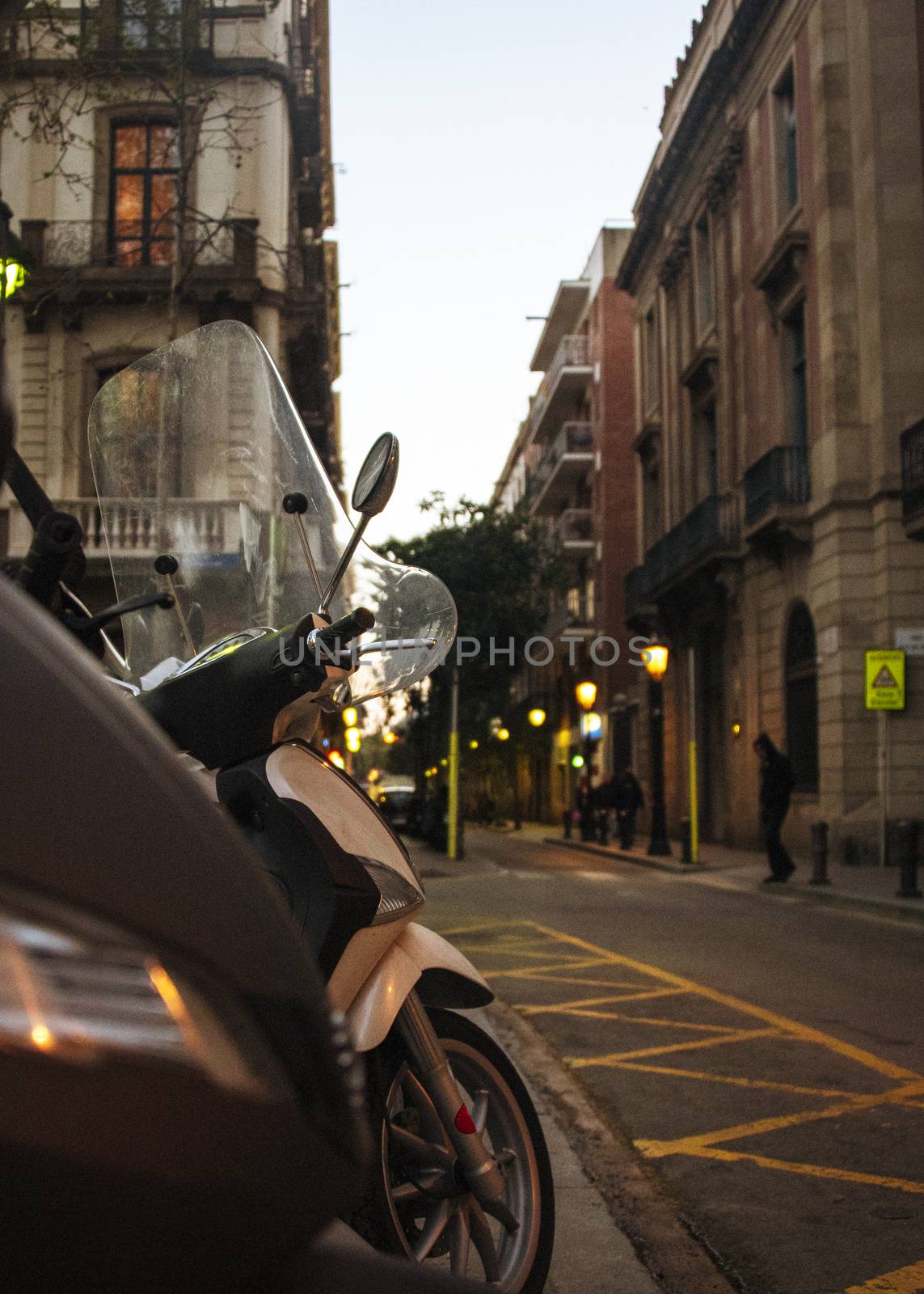 SPAIN,  BARCELONA aPRIL 2018 - Mopeds at the side of the road, early evening