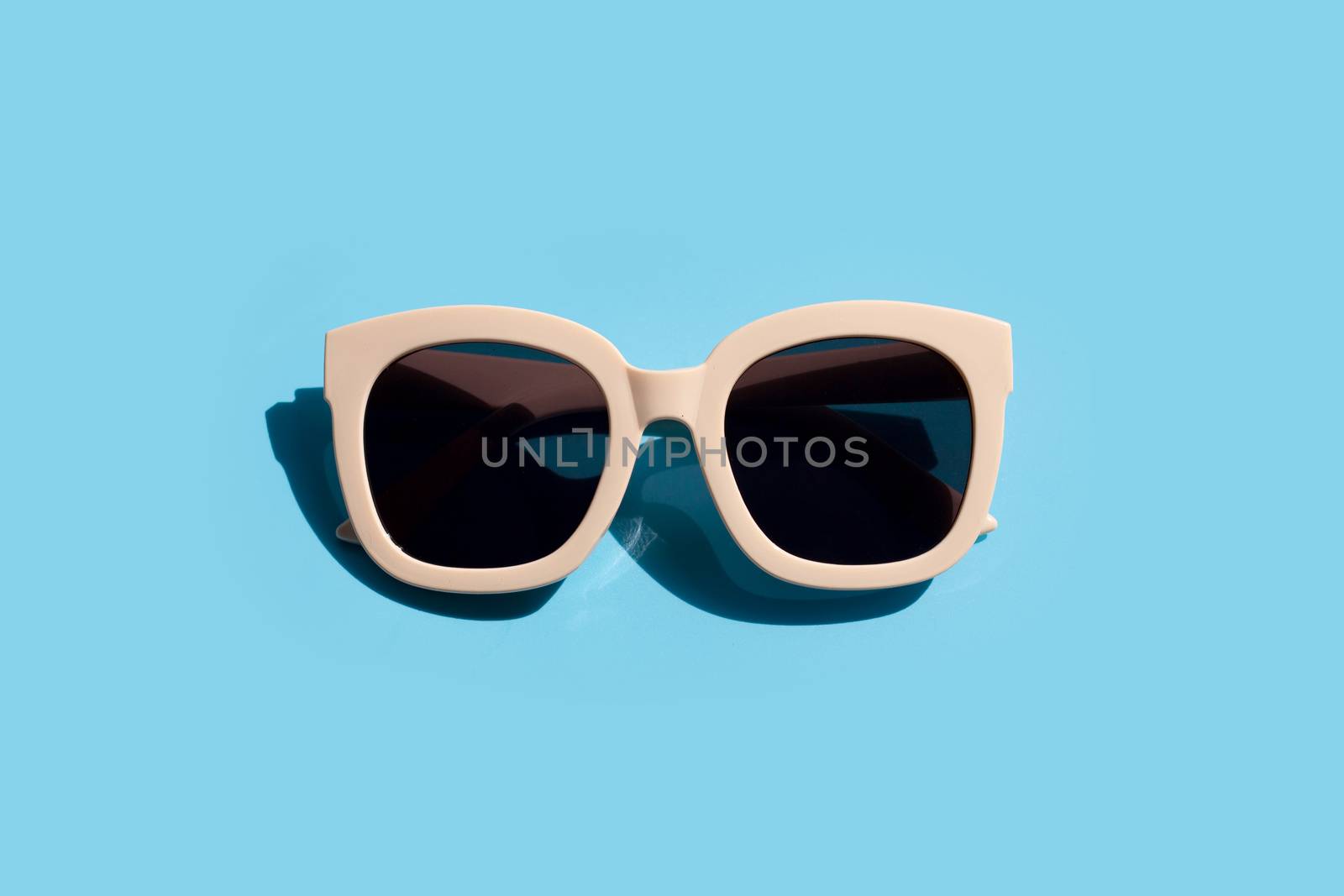 Sunglasses on blue background. Enjoy holiday concept. Copy space