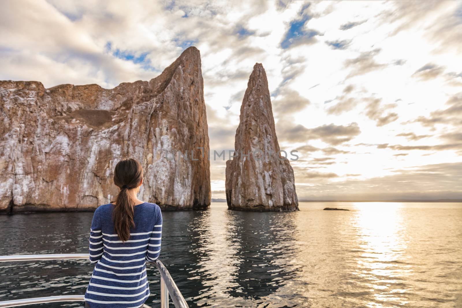 Galapagos Cruise ship tourist on boat looking at Kicker Rock nature landscape by Maridav