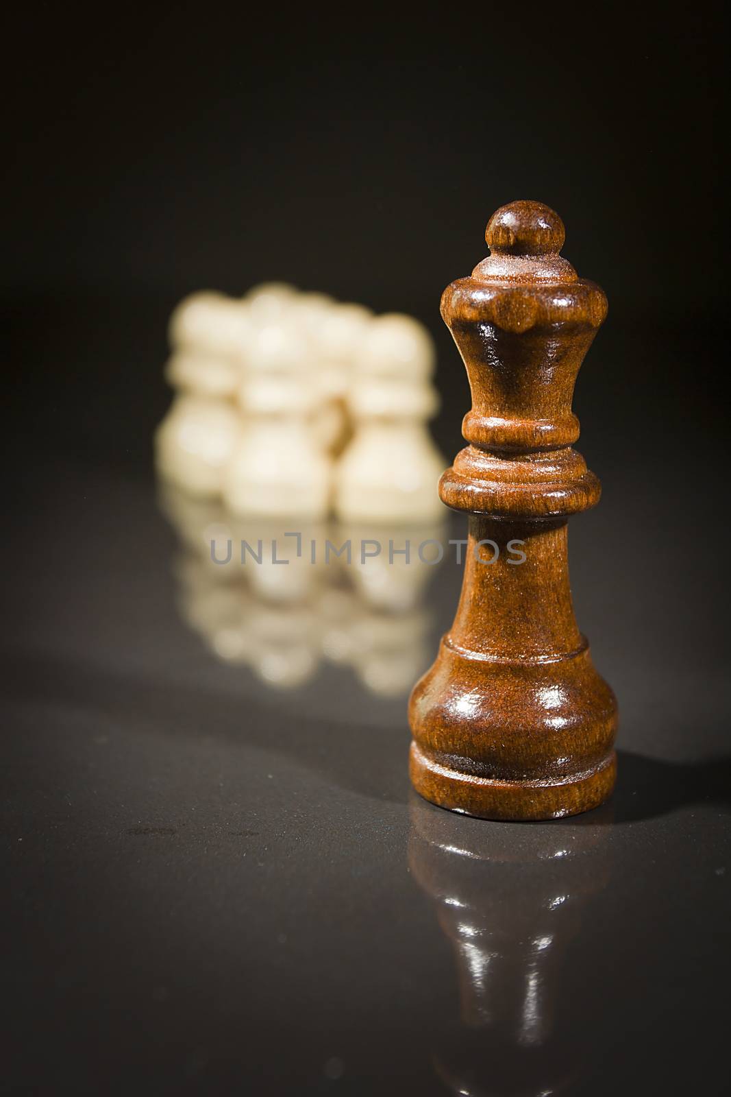 Chess pieces on a reflective surface by VIPDesignUSA