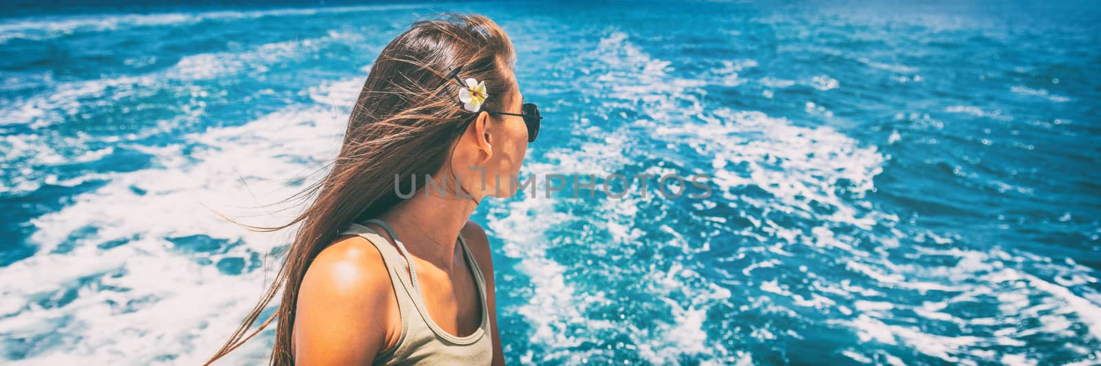 Cruise travel vacation woman relaxing by the water looking at Caribbean sea. Panoramic banner of tourist girl enjoying tropical holidays. by Maridav