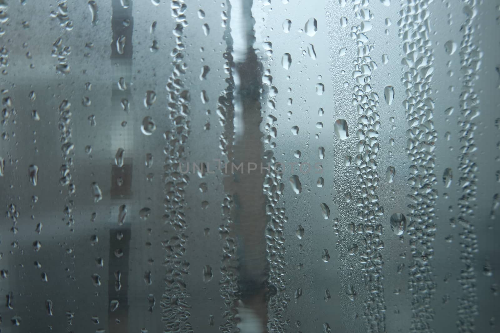 Bright grey color glassy texture, with water drops on it. Water drop glassy background