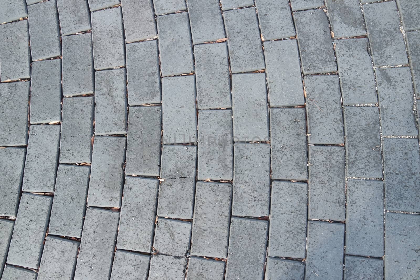 A background of a weathered old exterior brick floor by Photochowk