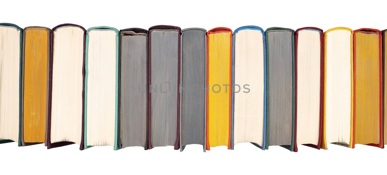 Stack of hardcover books on bookshelf. Close-up view of multicolored vintage hardback books isolated on white background. Flat lay headline panorama banner.