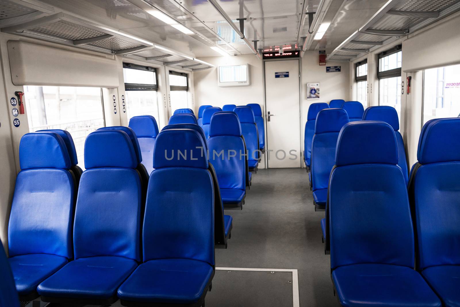 The interior of the transfer train to the airport. Rows of blue armchairs. Without people by Try_my_best