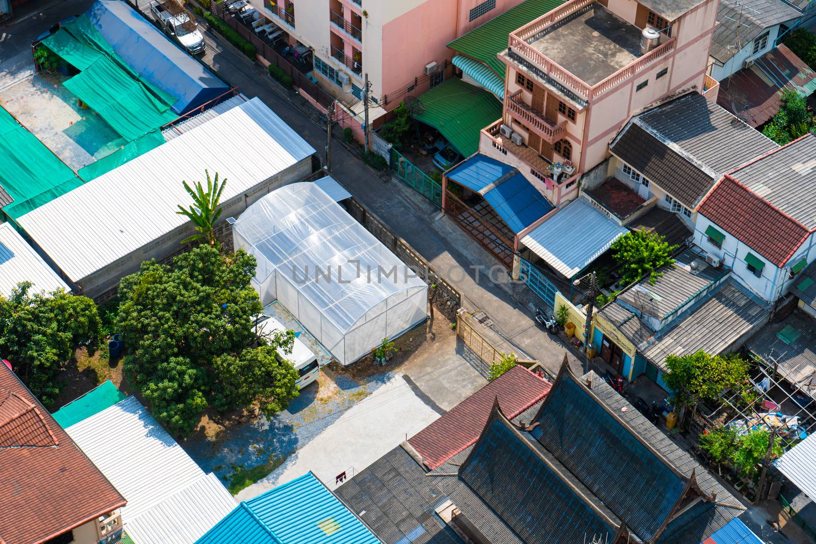 View from the high floor of the streets of Bangkok. Tall buildings and roofs of small houses. City landscape by Try_my_best