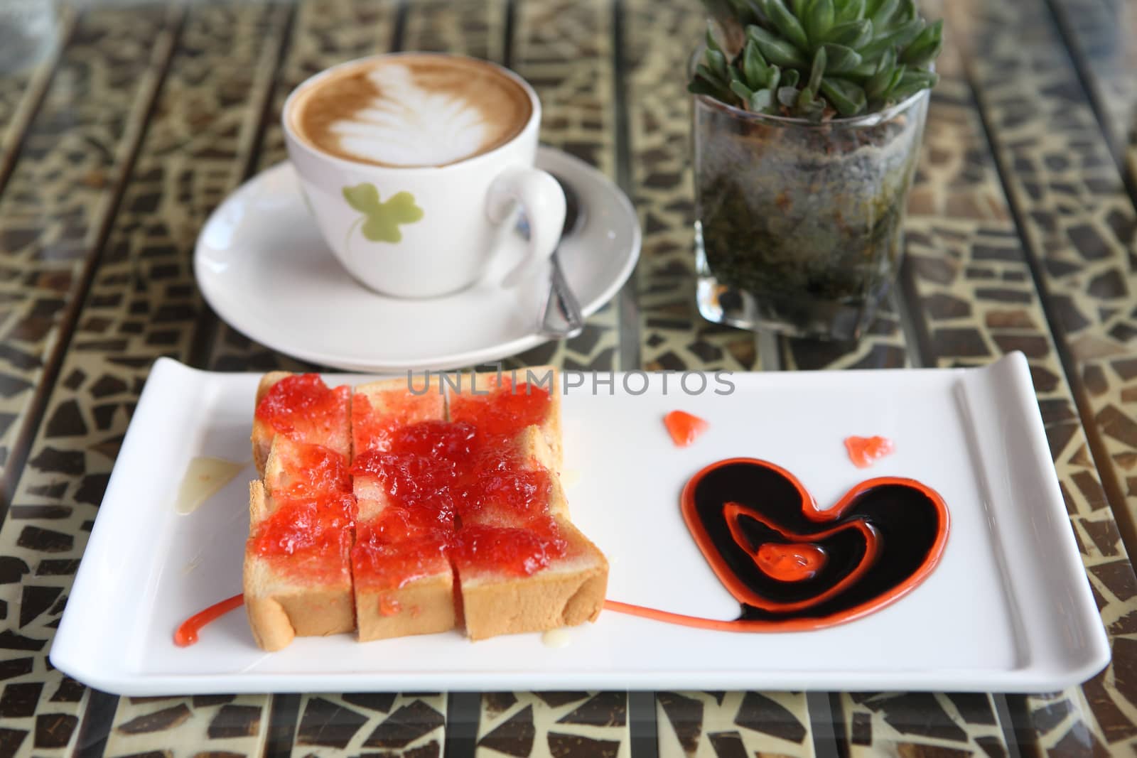slice of bread with strawberry jam and coffee by piyato