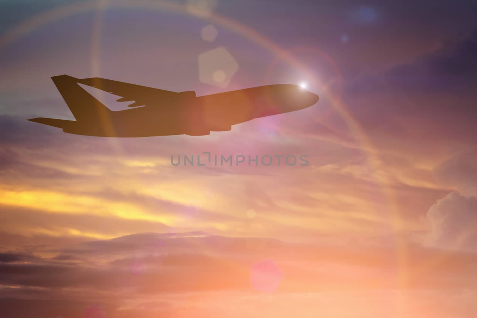 Silhouette of Airplane take off on the Colorful dramatic sky with cloud at sunset background.