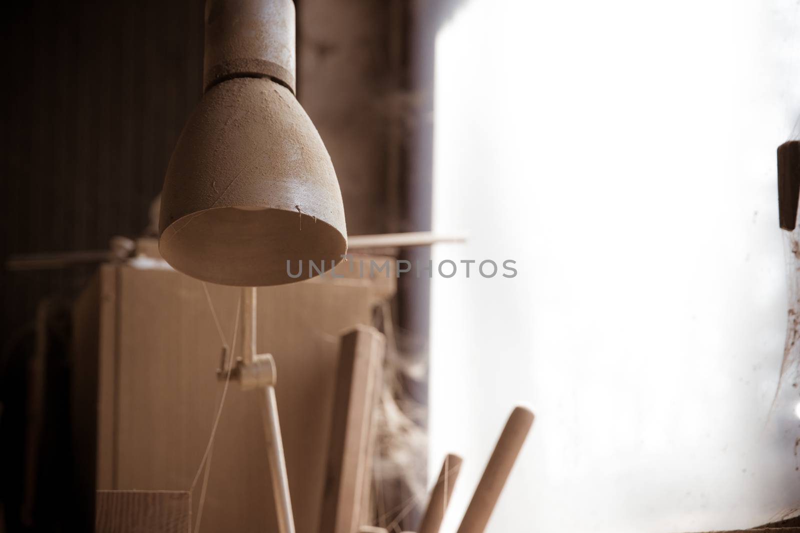 old dusty lamp in carpentry workshop.