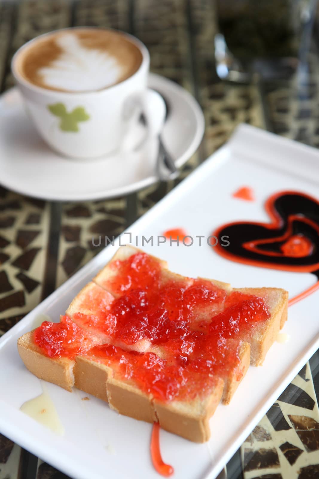 slice of bread with strawberry jam and coffee by piyato