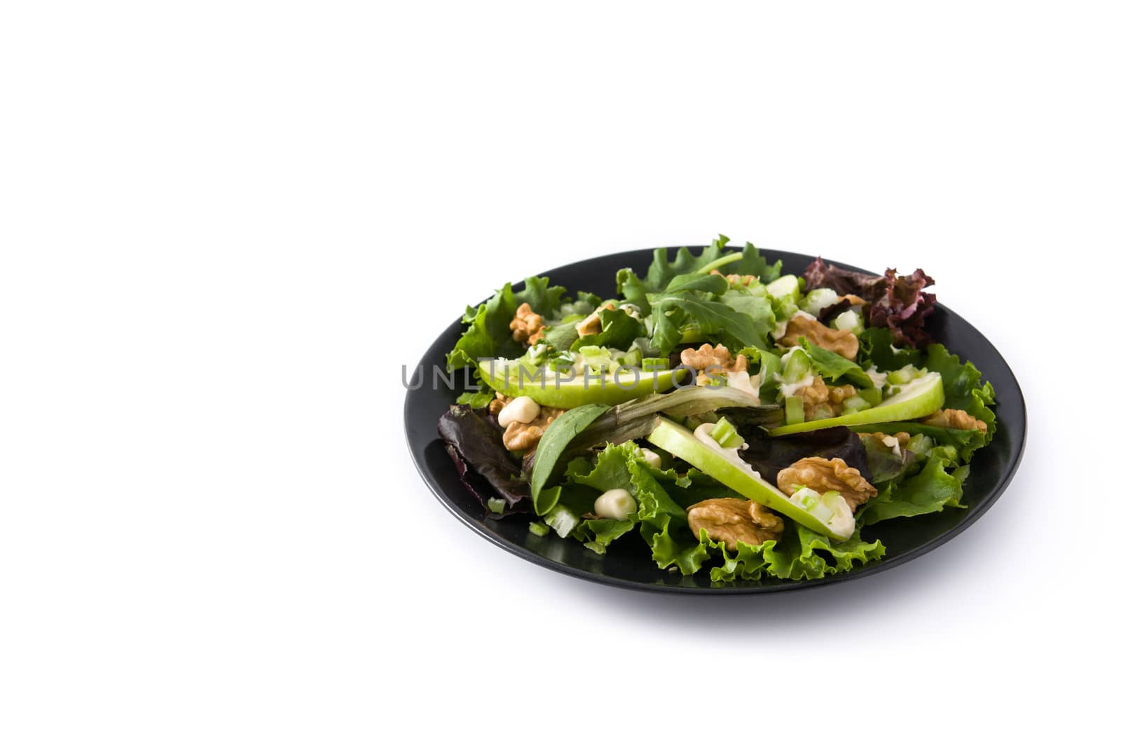 Fresh Waldorf salad with lettuce, green apples, walnuts and celery isolated on white background