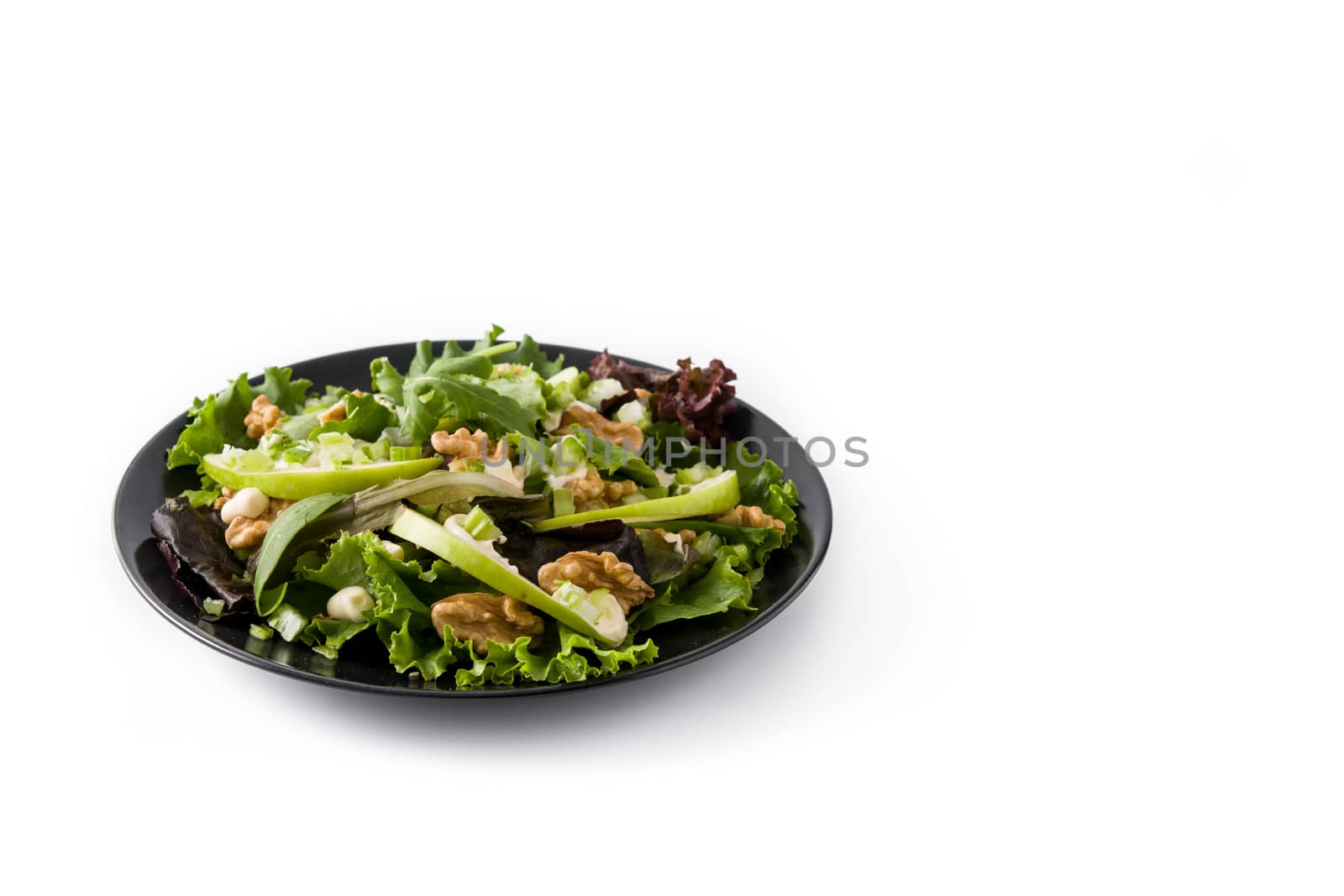 Fresh Waldorf salad with lettuce, green apples, walnuts and celery isolated on white background