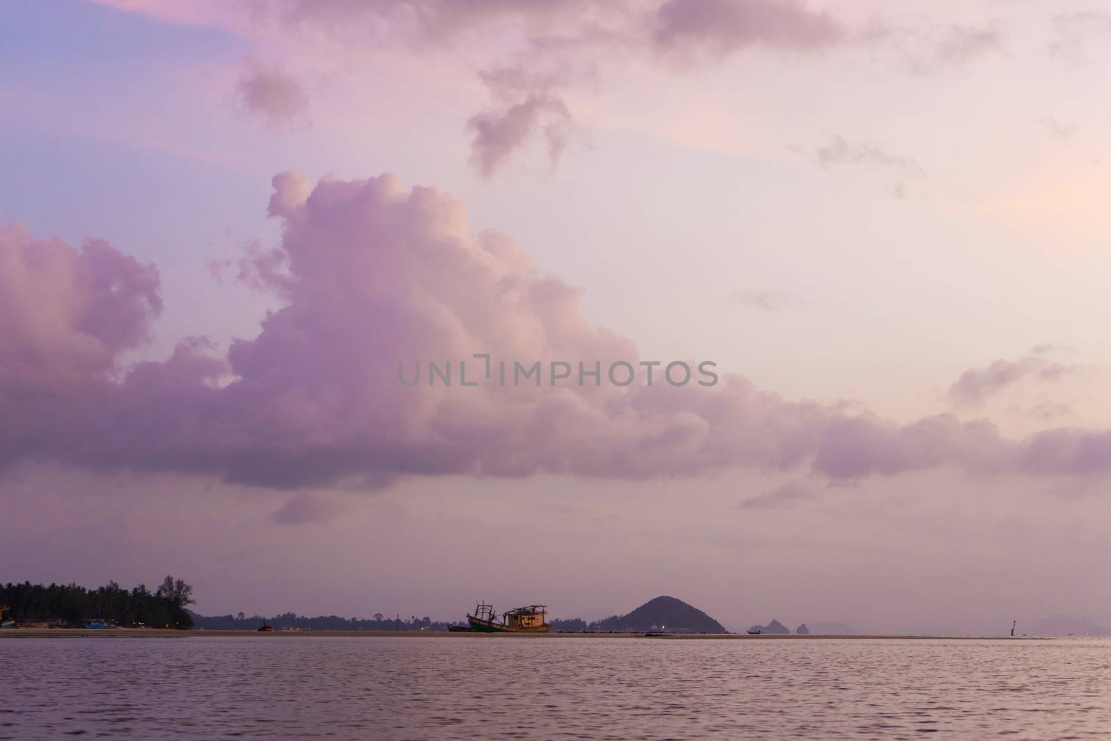 Burning bright sky during sunset on a tropical beach. Sunset during the exodus, the strength of people walking on water.