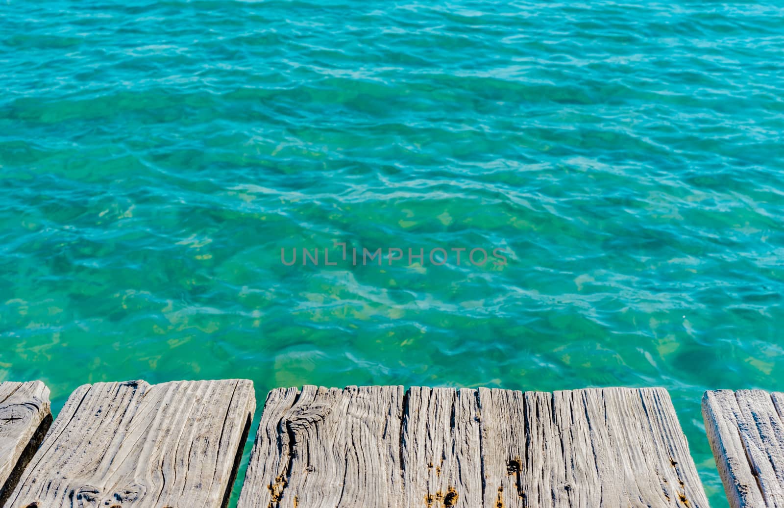 Soft sea wave water and wooden pier background