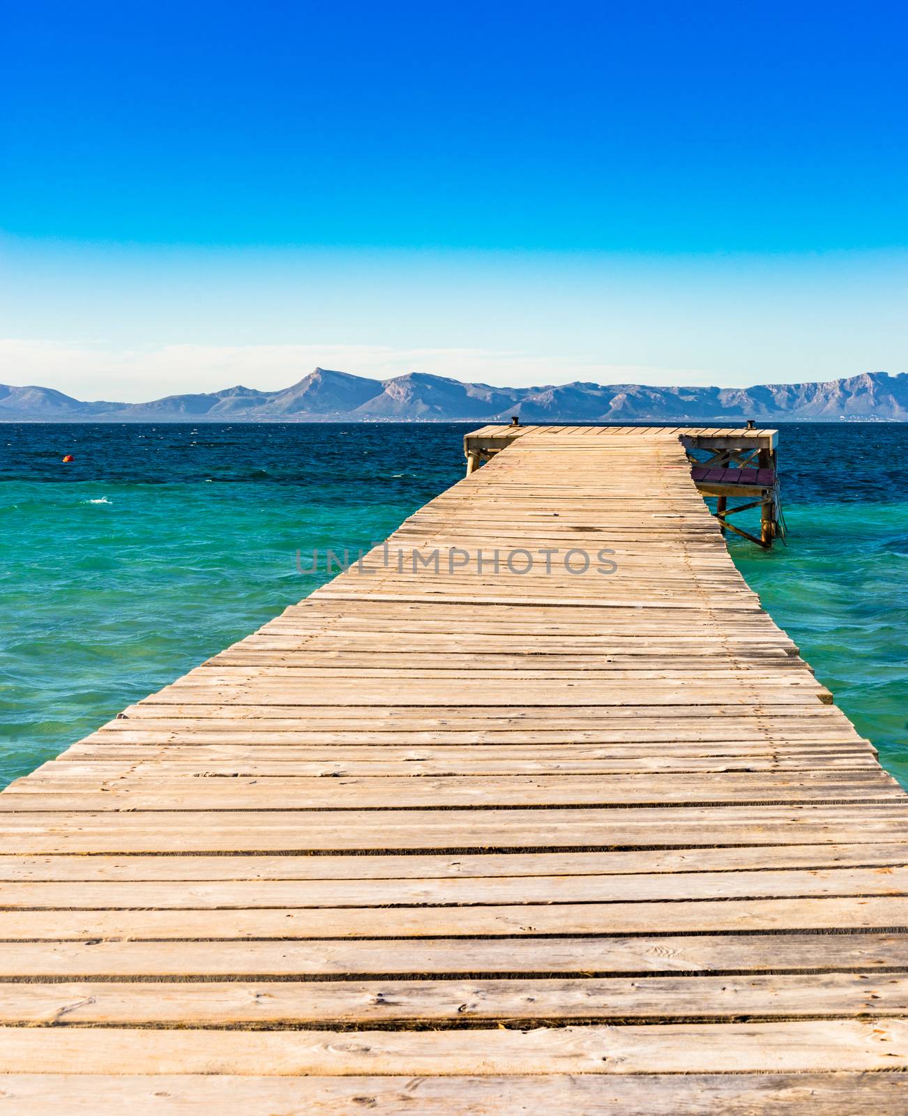 View of wooden pier at the bay of Alcudia on Mallorca, Spain Balearic islands