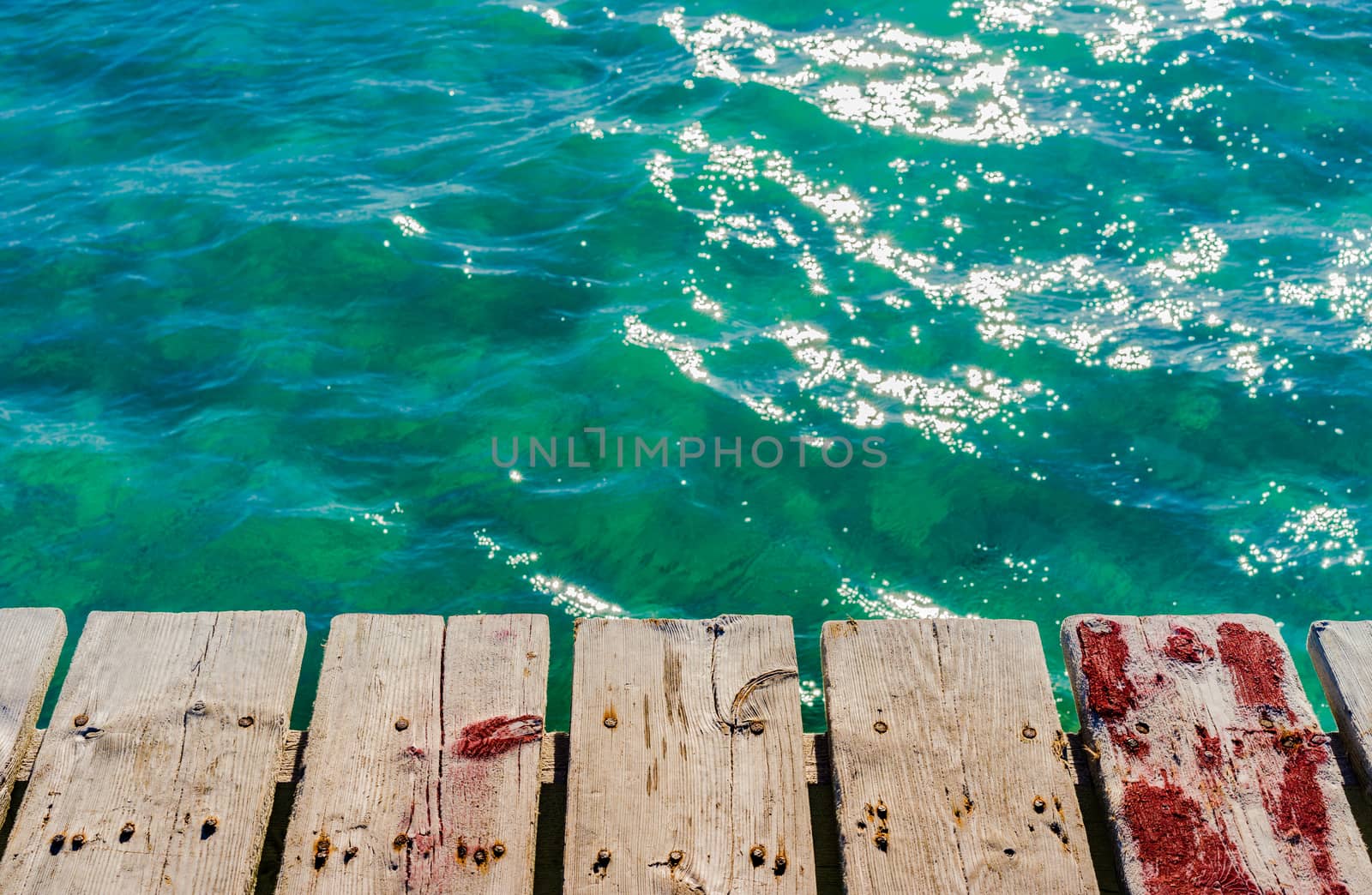 Soft sea wave water and wooden pier background
