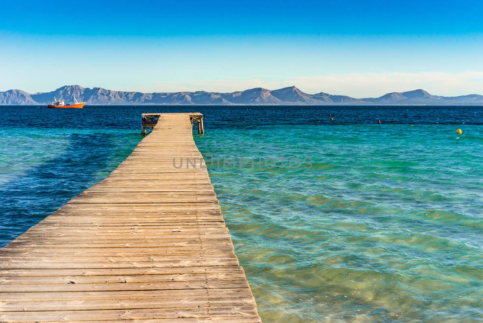 Wooden jetty at the bay of Alcudia on Majorca island, Spain Mediterranean Sea