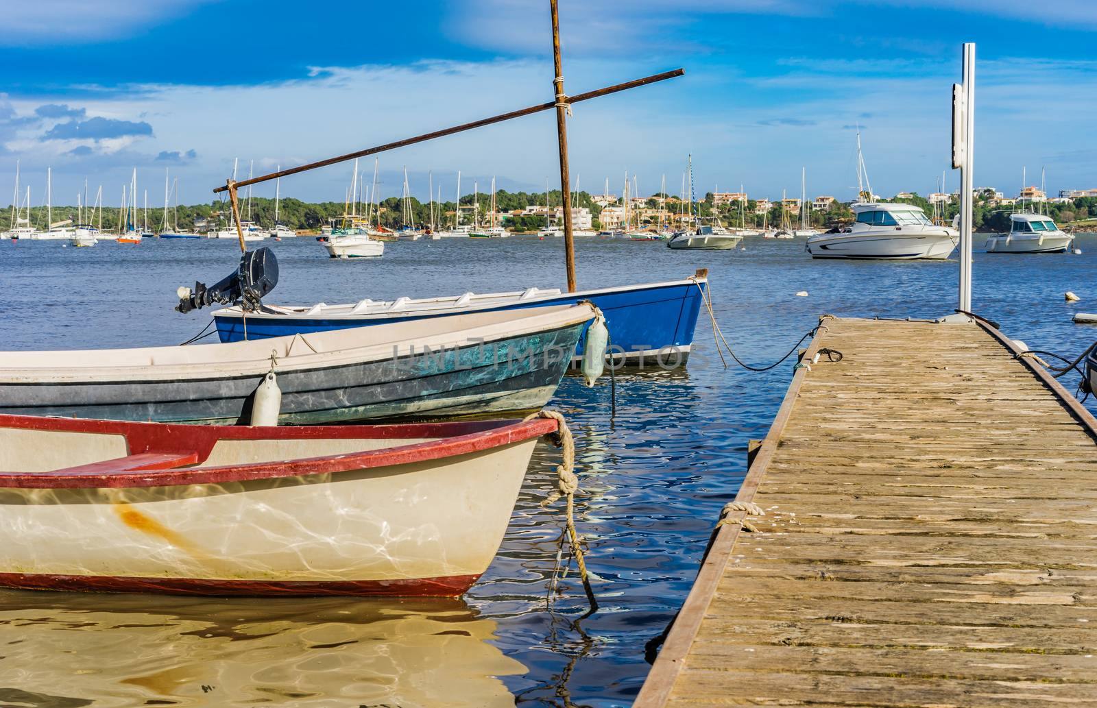 Harbour bay with anchoring boats an wooden jetty