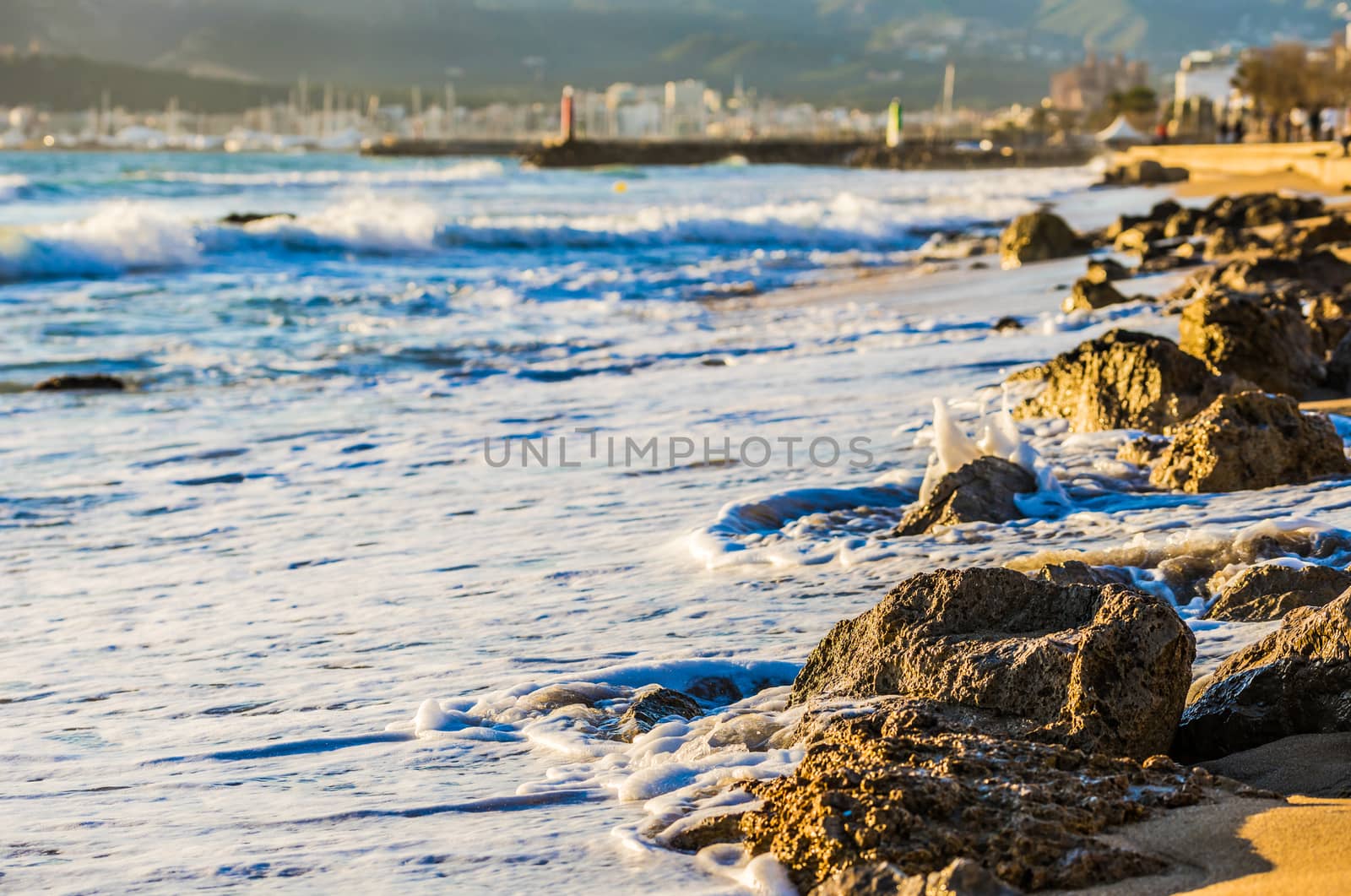 Foamy waves on rocky beach coastline

