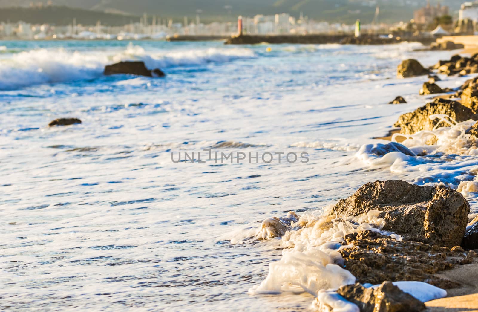Seascape with foamy sea water at beach and beautiful light 