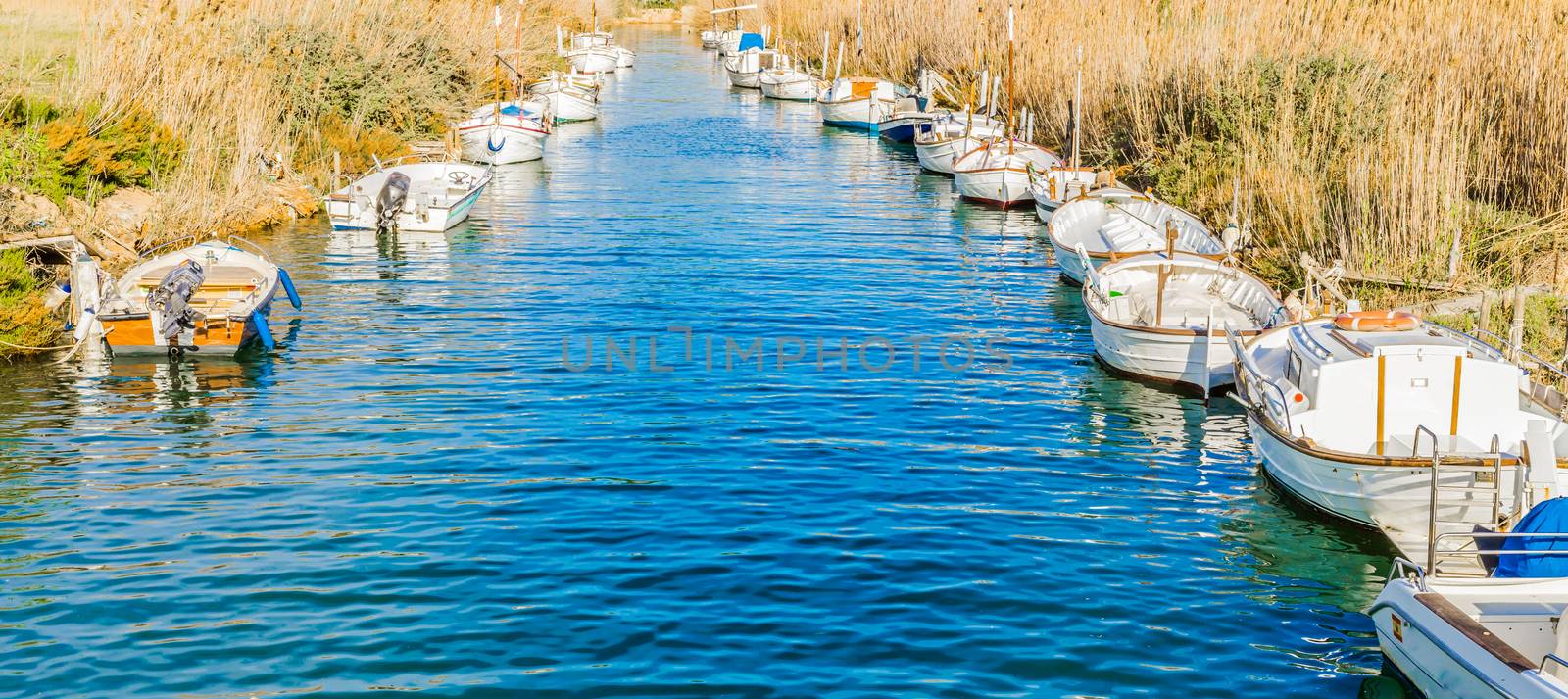 Idyllic view of canal with anchored boats by Vulcano