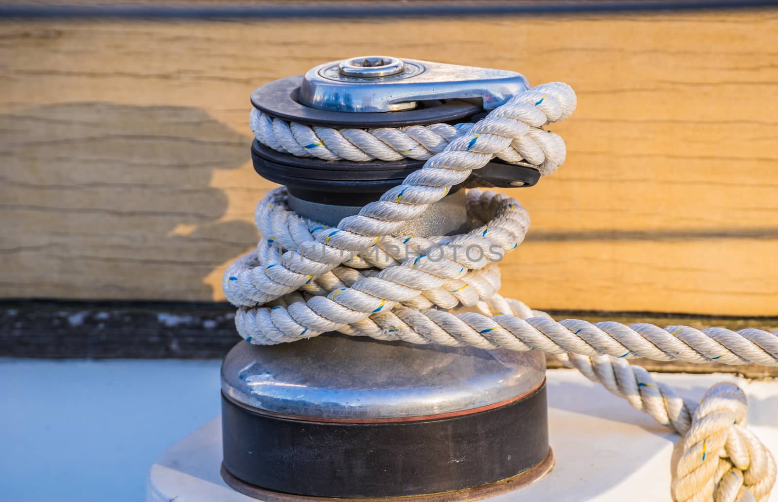 Close-up of winch with nautical rope on boat deck of old sailing yacht

