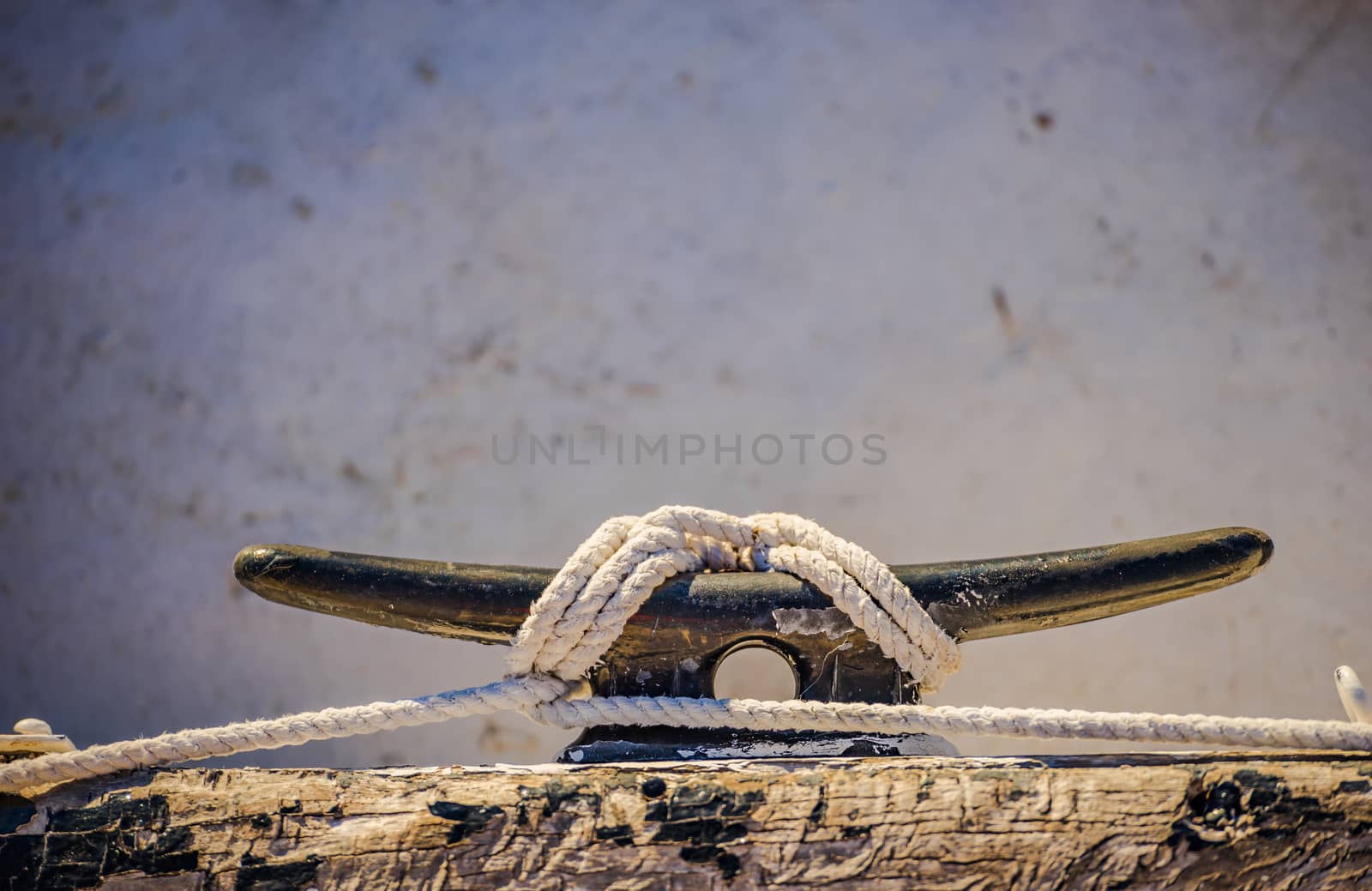 Close-up of cleat and rope on wooden boat deck