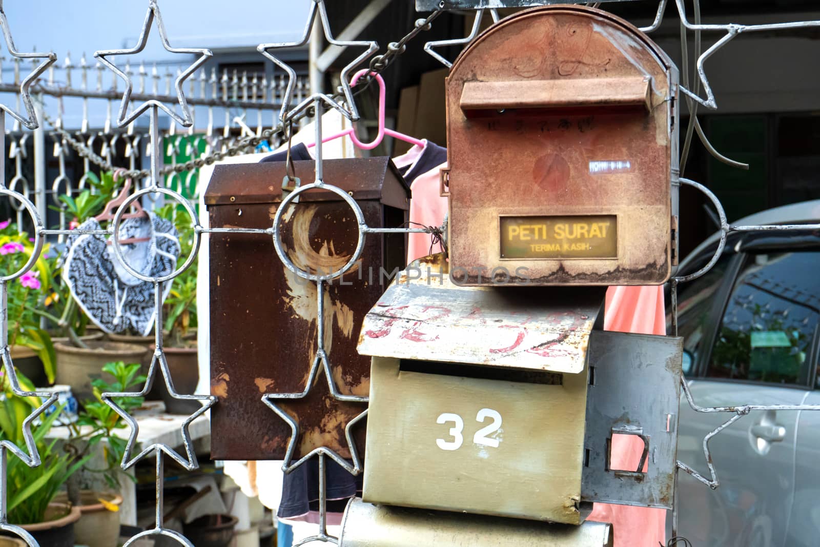 Old mailboxes on the fence close up.