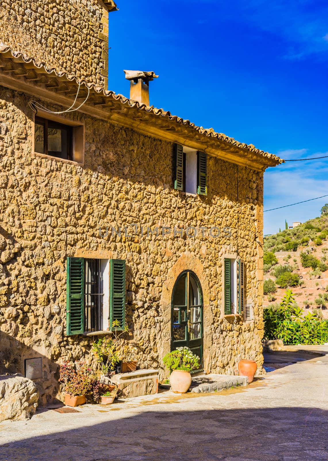 Front view of rustic mediterranean stone house