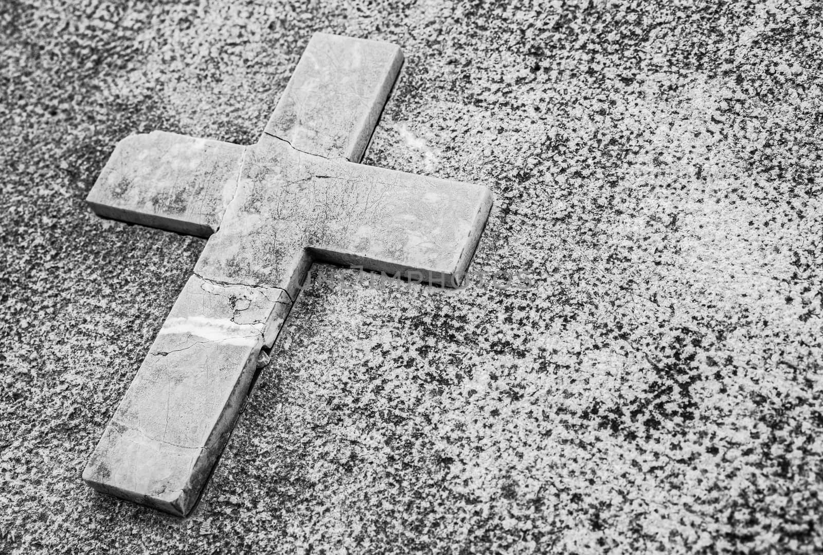 Paying his respects, tombstone with stone cross and copy space