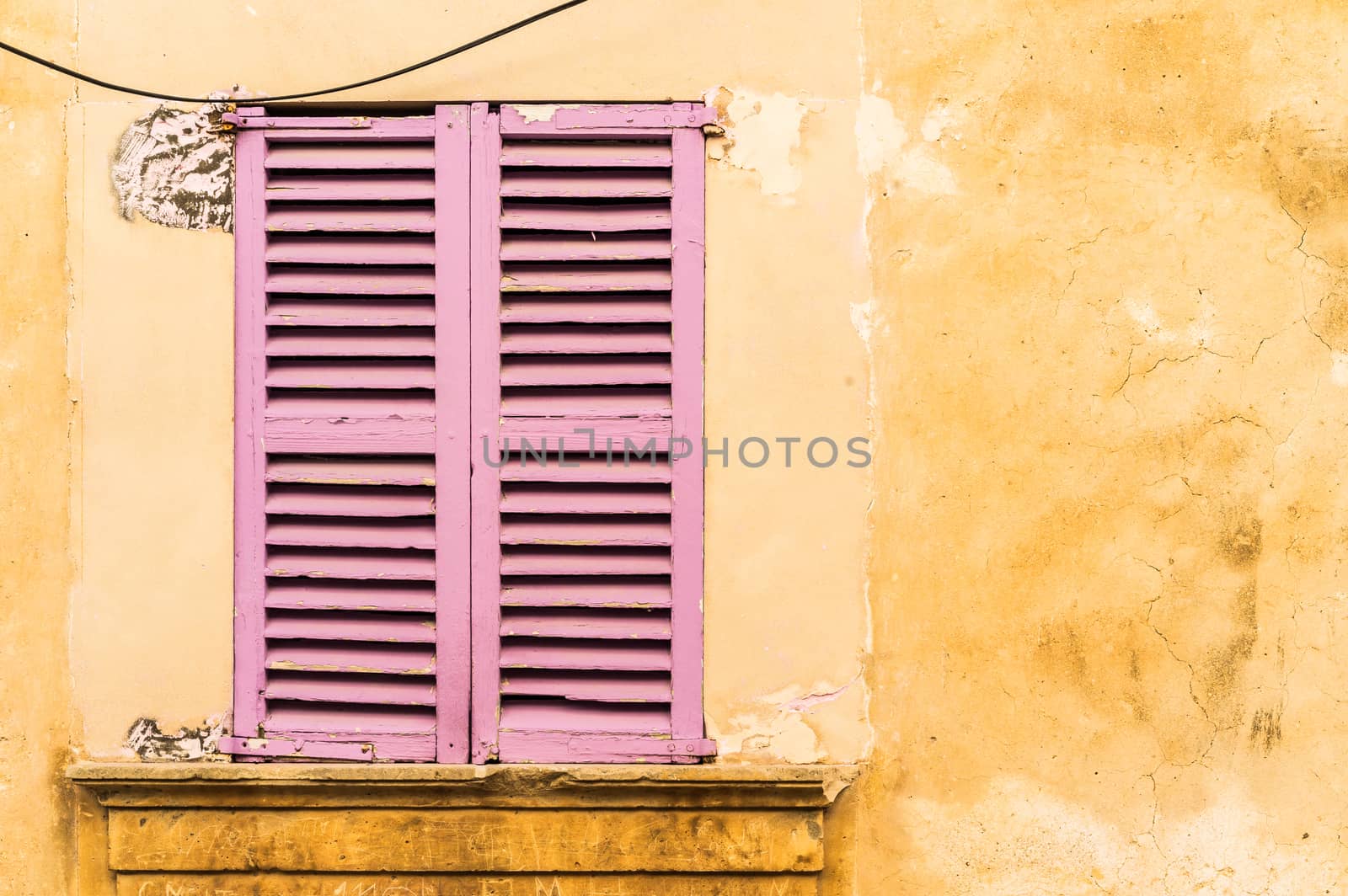 Detail view of wooden window shutters and wall background

