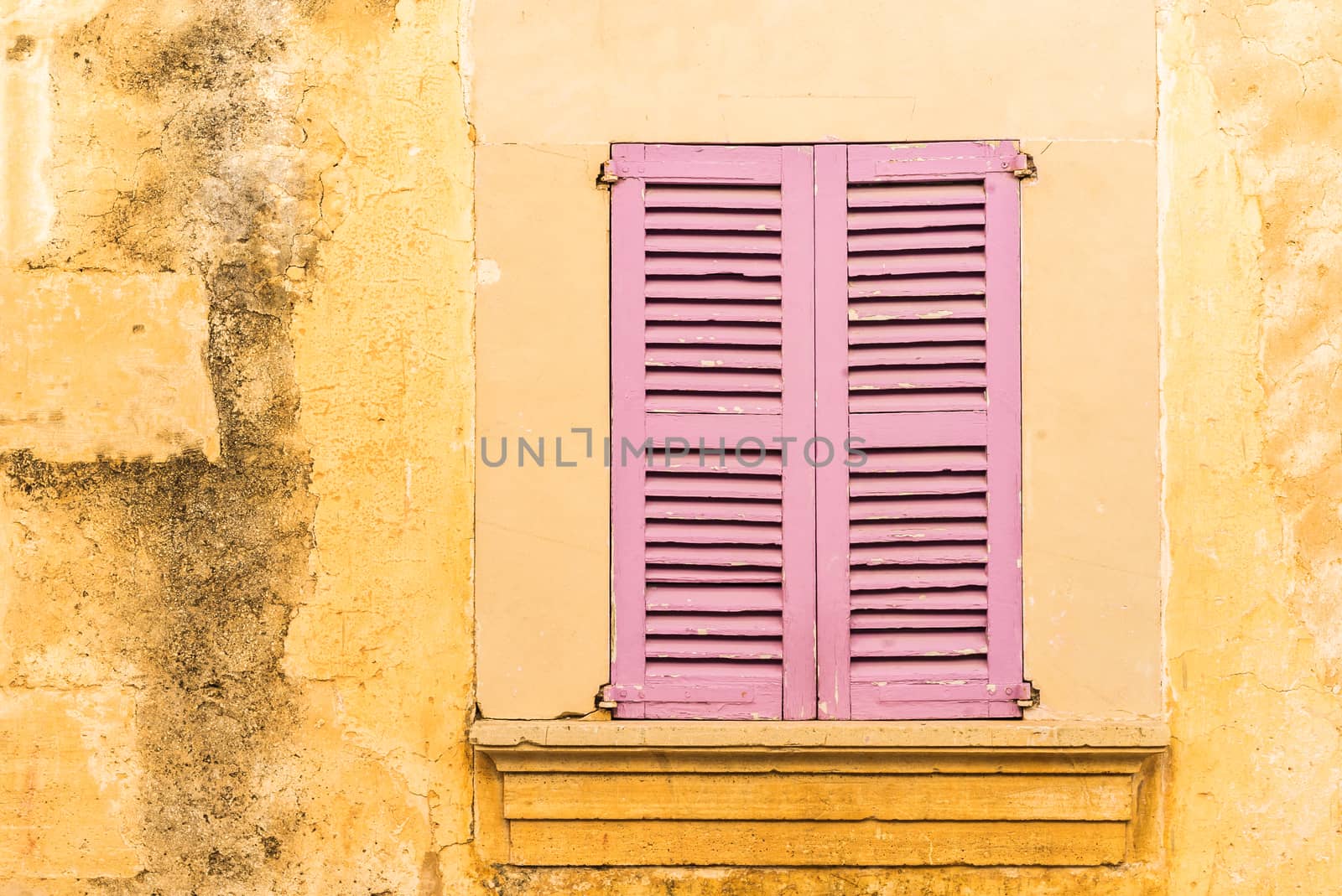 Old mediterranean window shutters and wall background 
