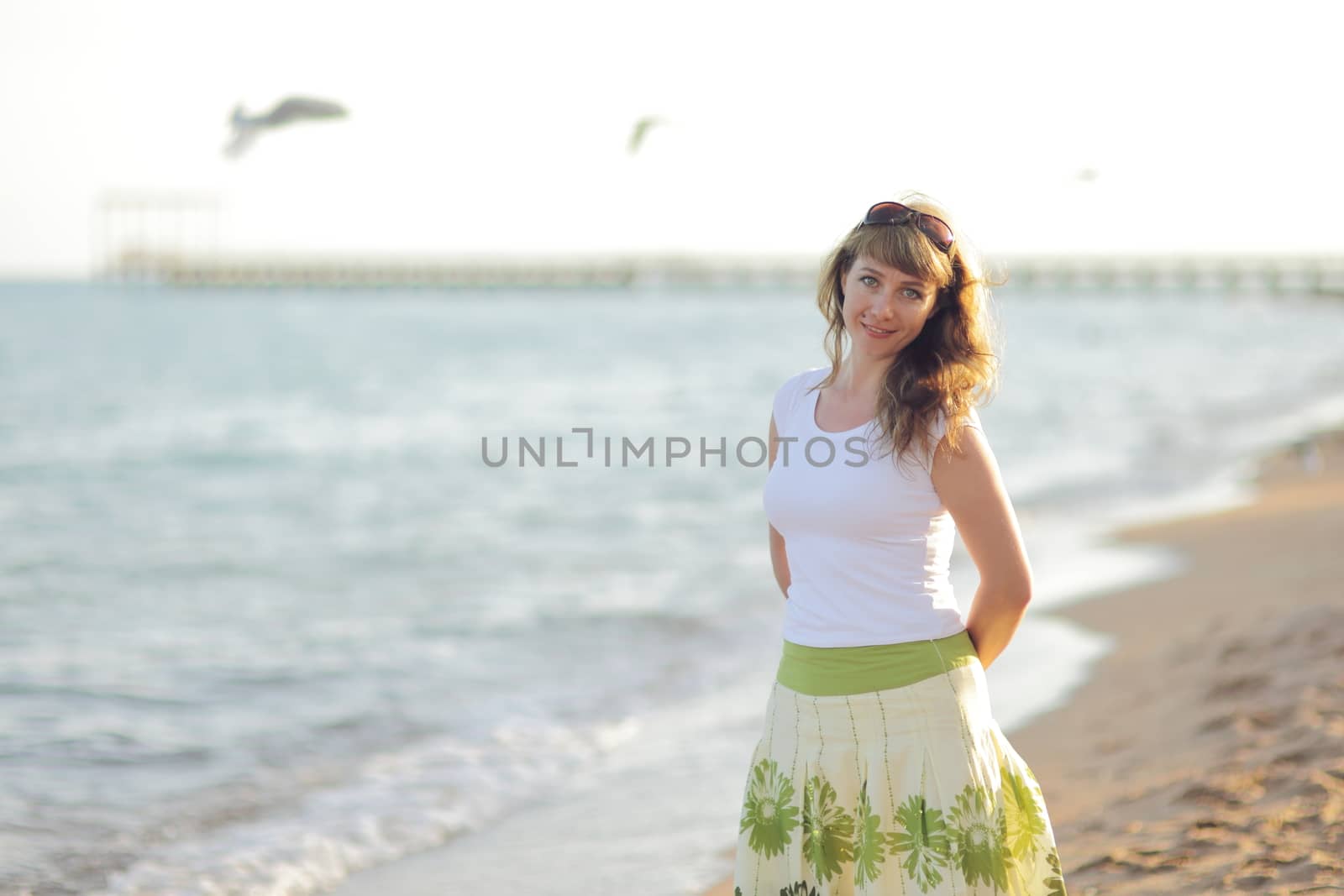 Young woman is relaxing on the beach at the pier. Vacation Travel Concept. High quality photo