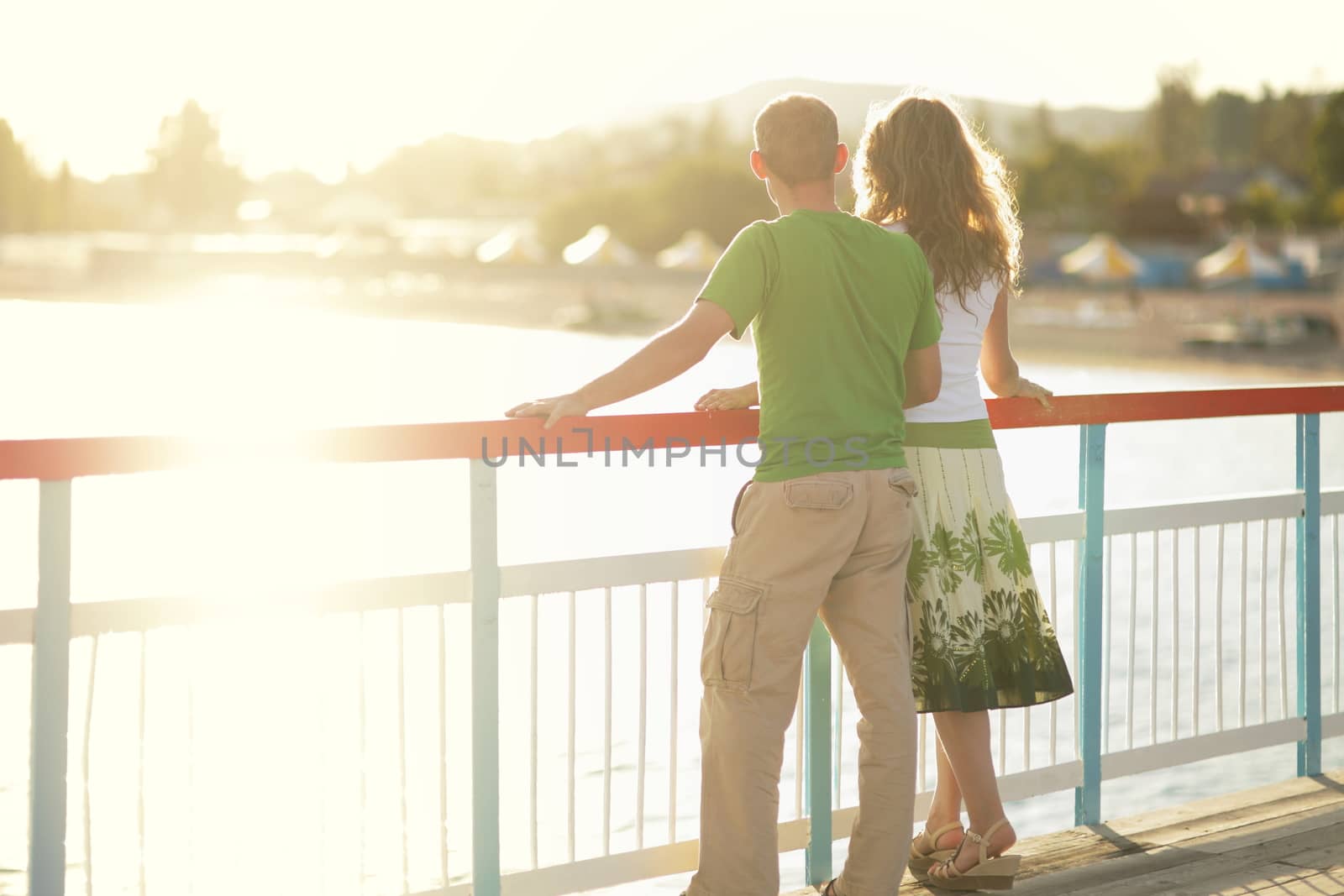 Couple resting on the beach on the pier. Vacation Travel Concept. High quality photo