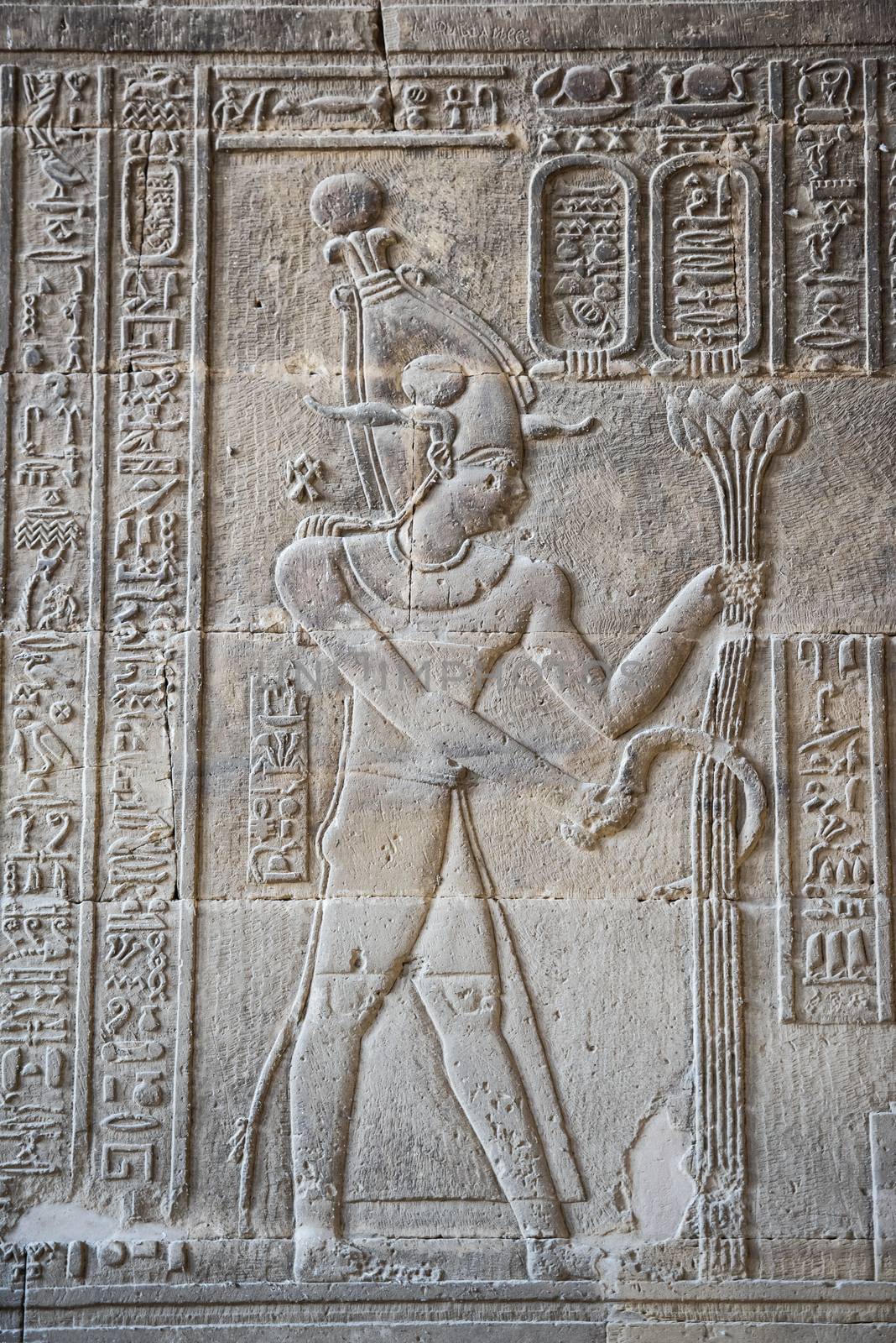 Hieroglypic carvings on wall at the ancient egyptian temple of Khnum in Esna showing god Osiris