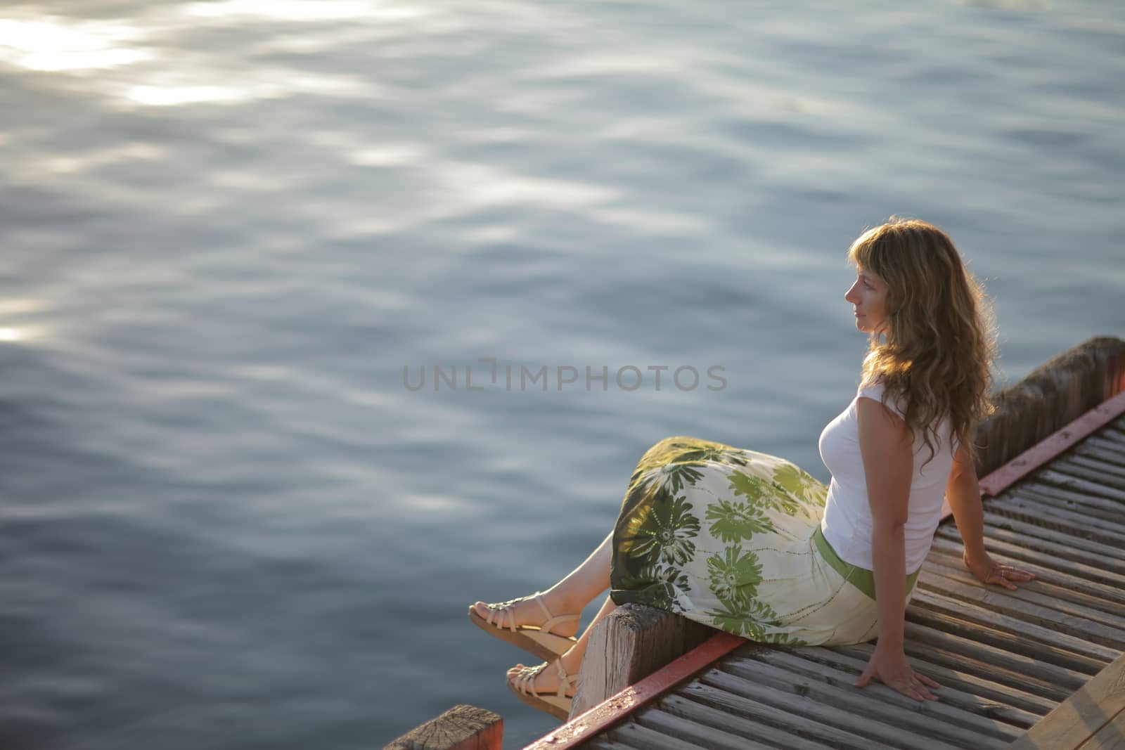 Young woman is relaxing on the beach at the pier. Vacation Travel Concept. High quality photo