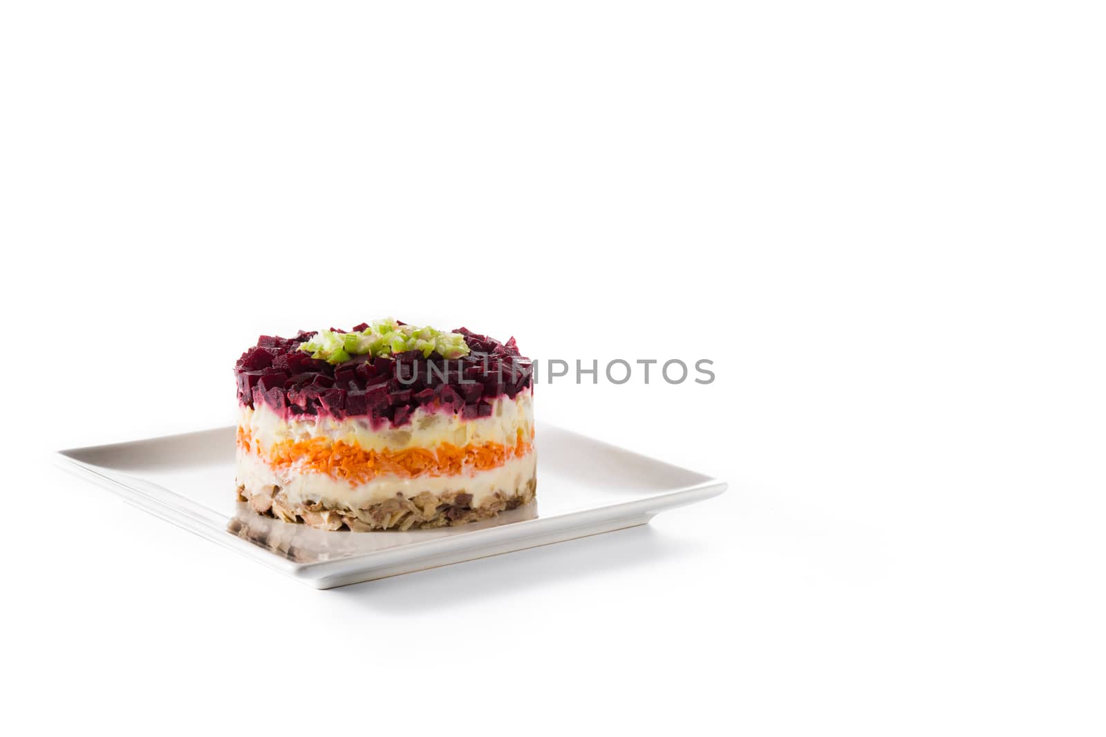 Traditional Russian herring salad with beetroot and carrots isolated on white background