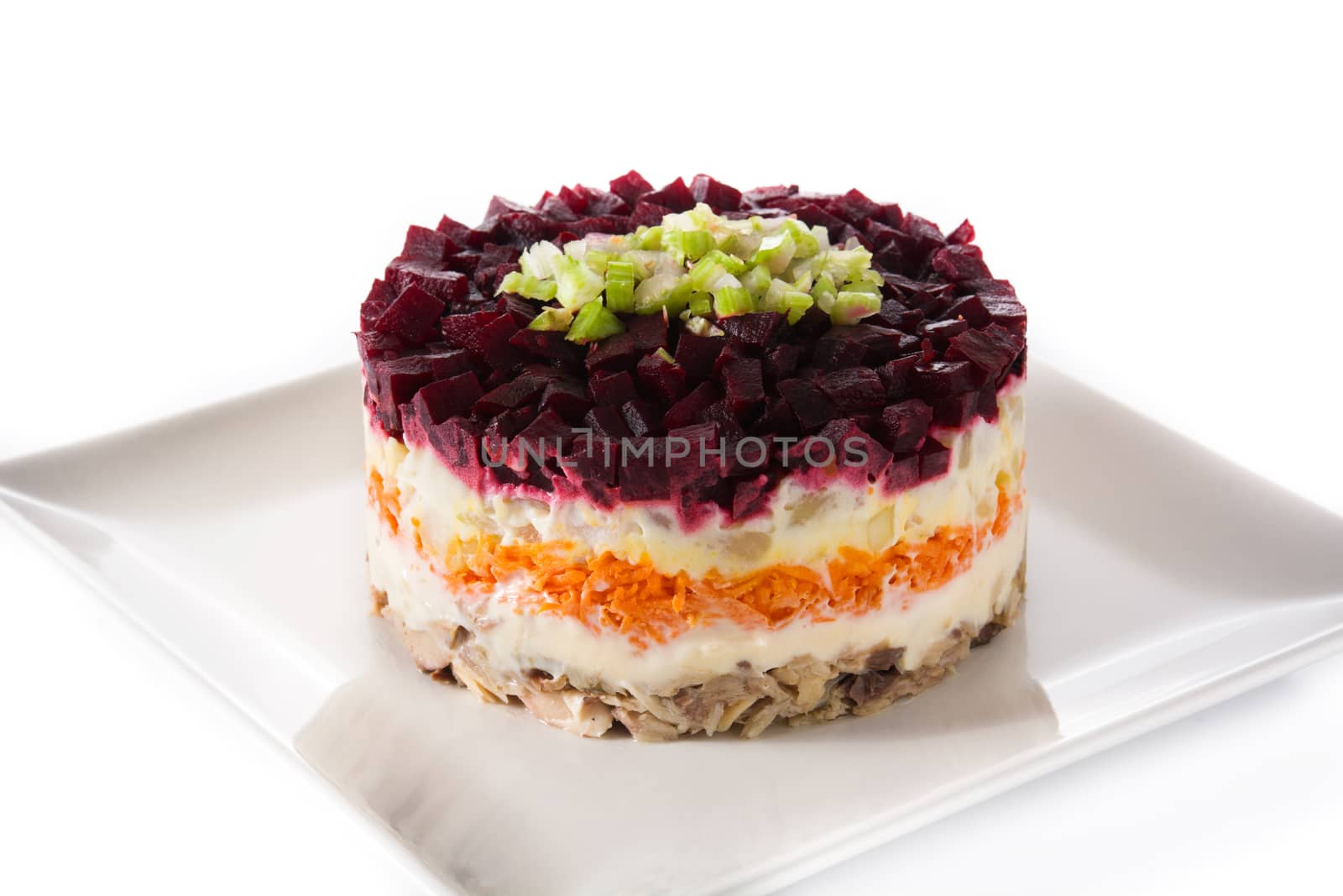 Traditional Russian herring salad with beetroot and carrots isolated on white background