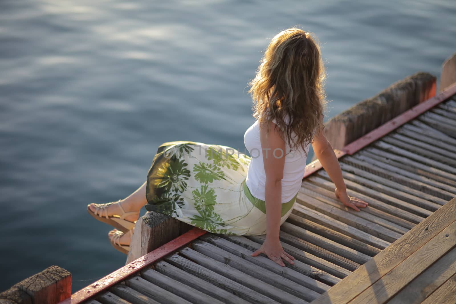 Young woman is relaxing on the beach at the pier. Vacation Travel Concept by selinsmo
