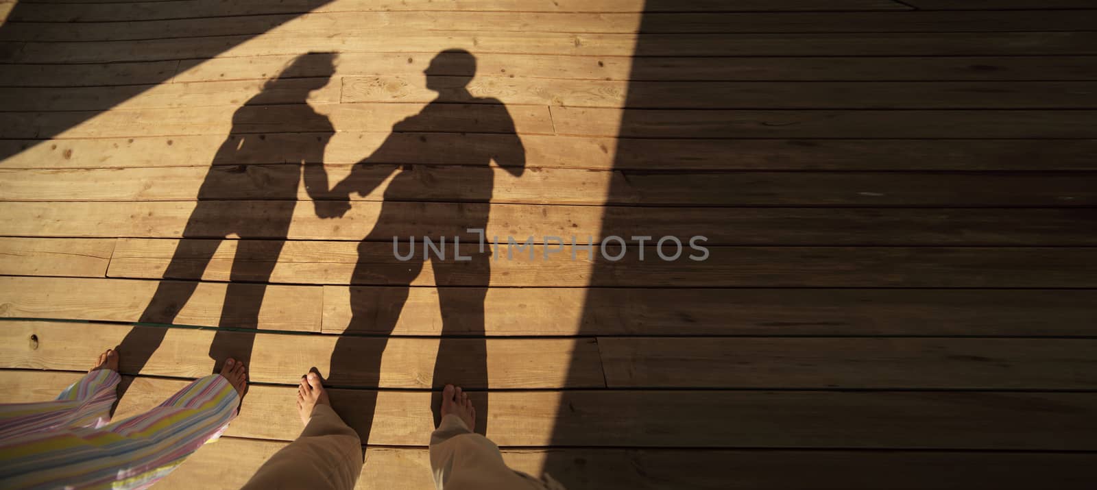 Couple resting on the beach on the pier. Vacation Travel Concept by selinsmo