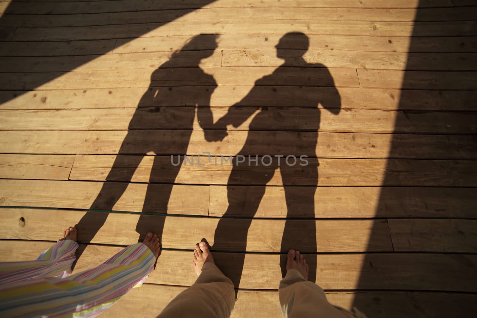 Couple resting on the beach on the pier. Vacation Travel Concept. High quality photo