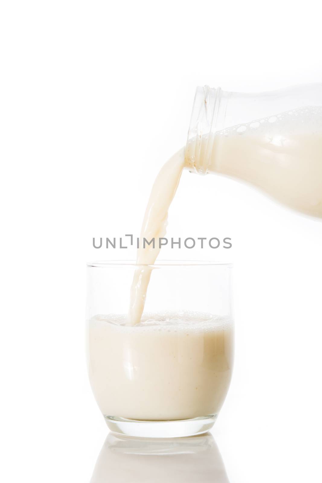 Oats milk in a bottle on wooden table