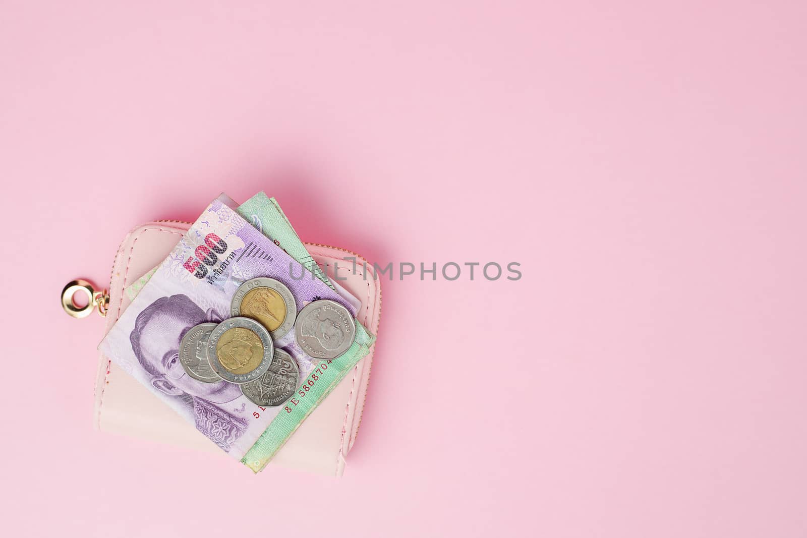 Thai currency banknote and money coins with wallet on pink background for business, finance, investment and saving money concept