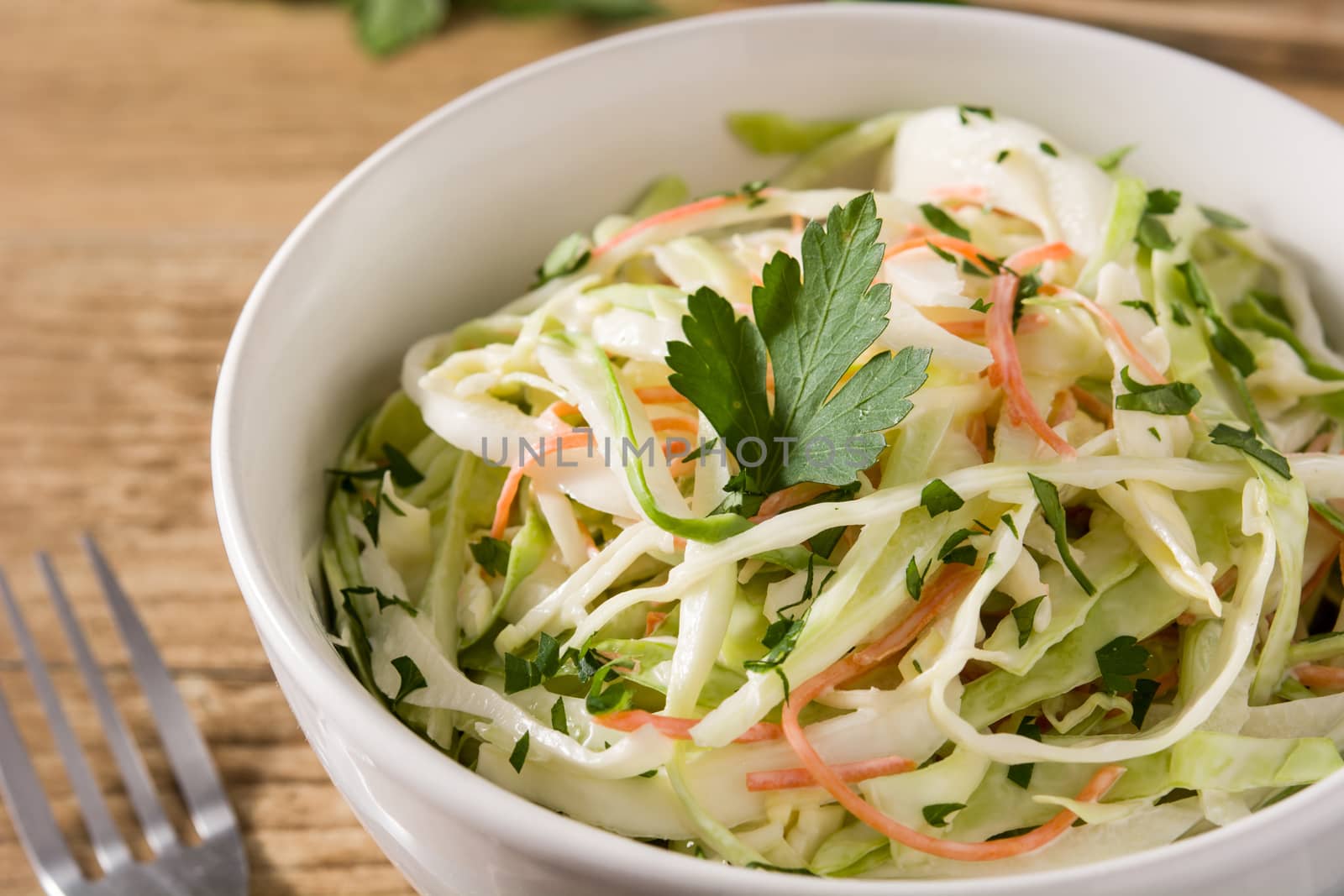 Coleslaw salad in white bowl by chandlervid85