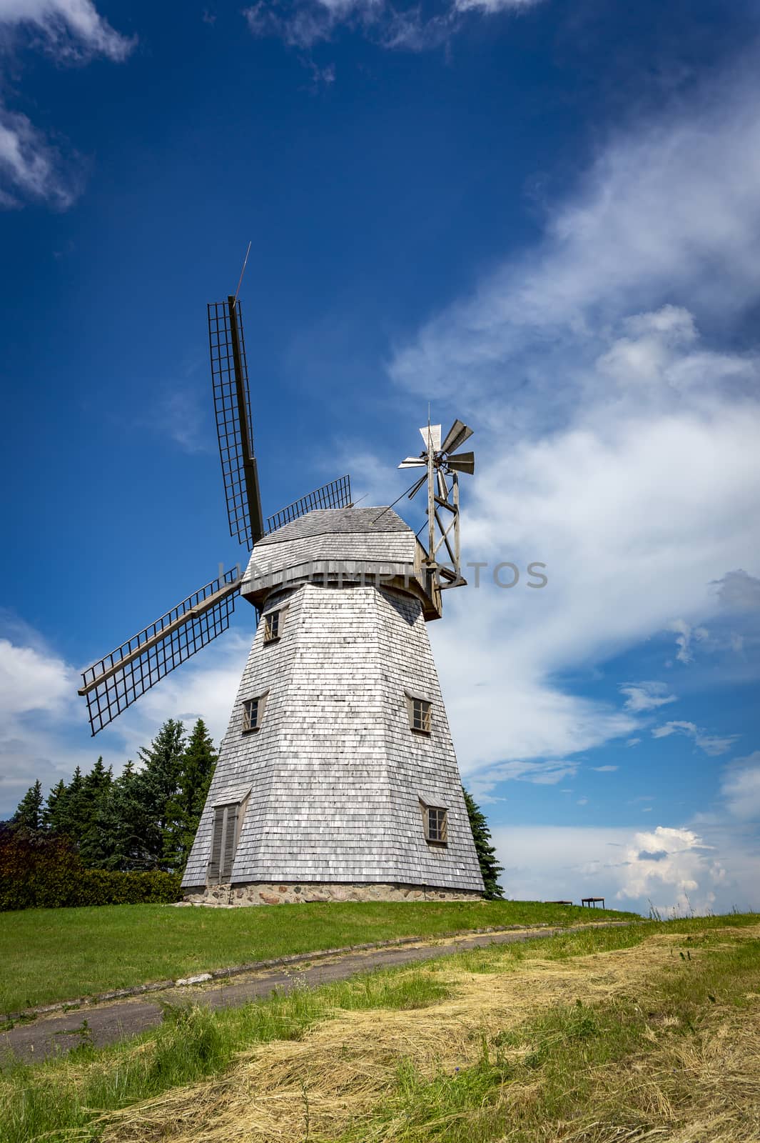 Old windmill in a country landscape by NetPix
