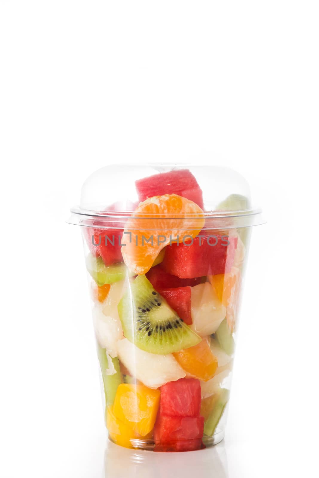 Fresh cut fruit in a plastic cup isolated on white background