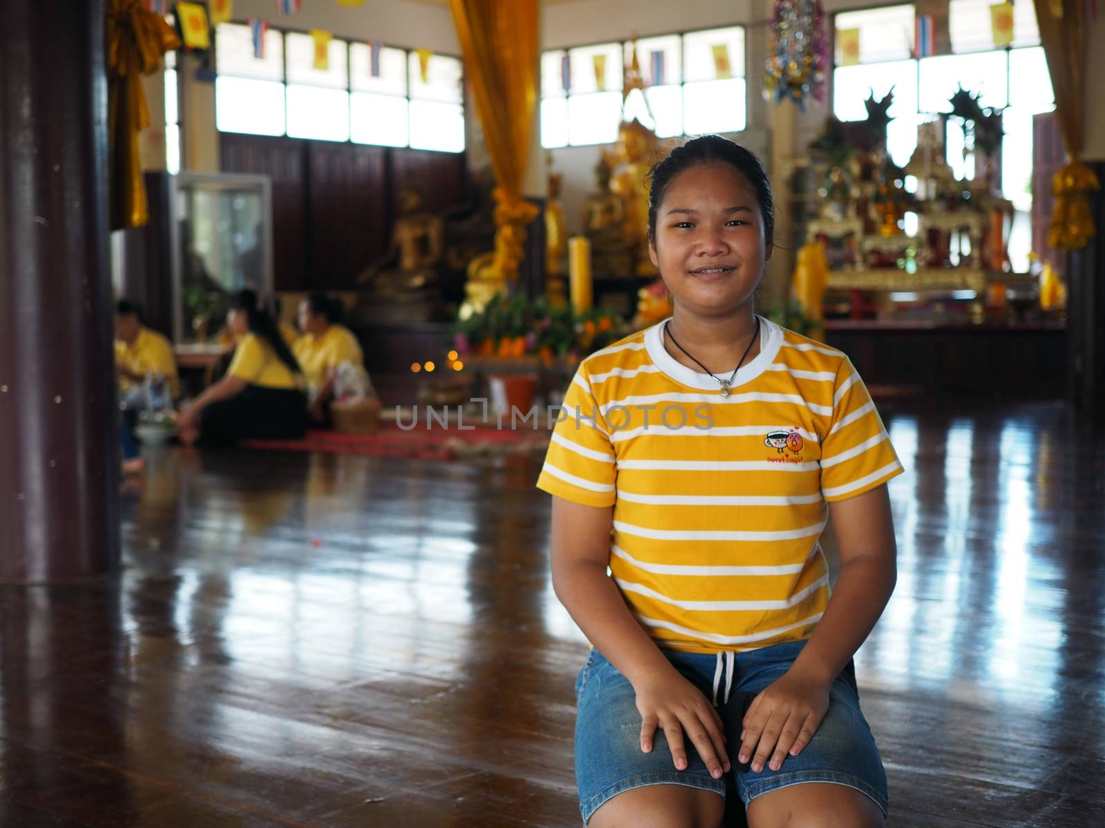 The girls wear yellow stripes. Living in the temple pavilion Buddhist Lent Ceremony.