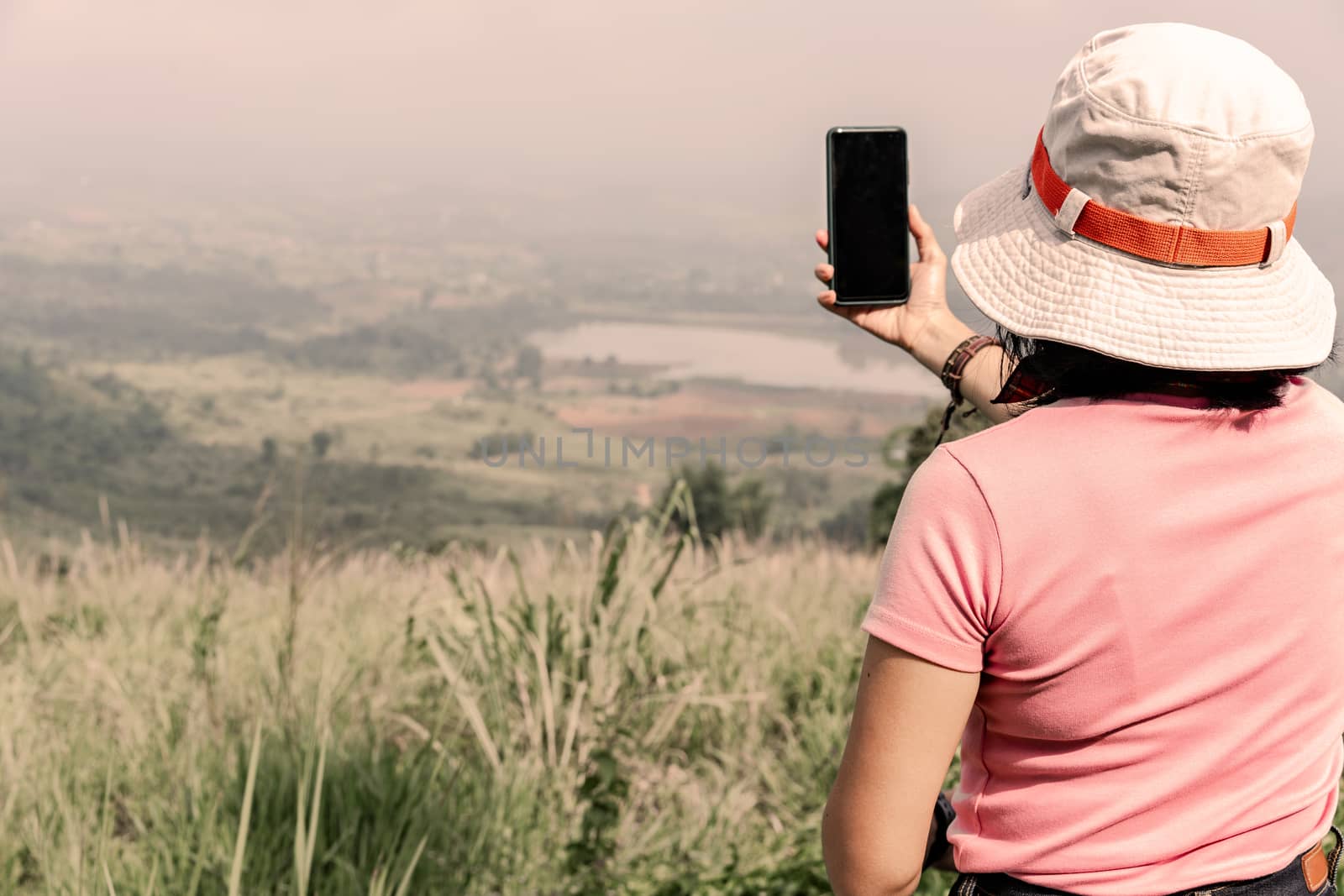 Tourists taking photo of natural scenery